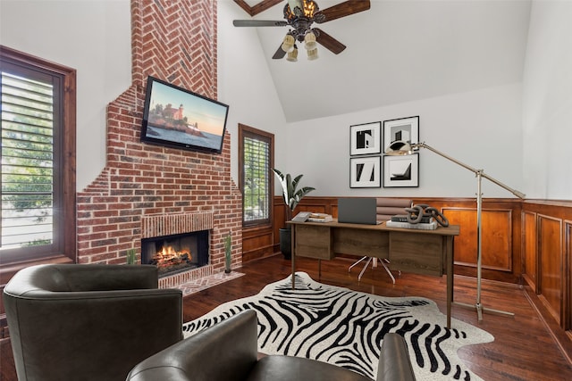 office area with a fireplace, dark hardwood / wood-style flooring, ceiling fan, and a wealth of natural light