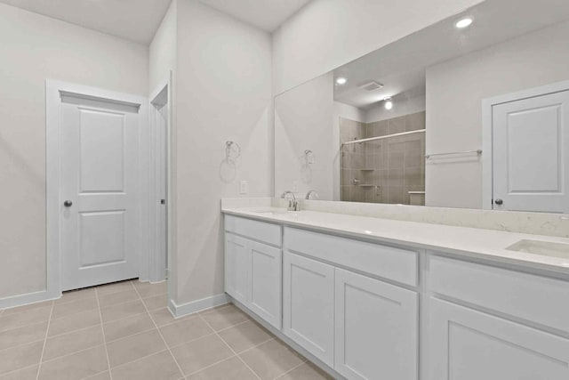 bathroom with tile patterned flooring, vanity, and a shower with shower door