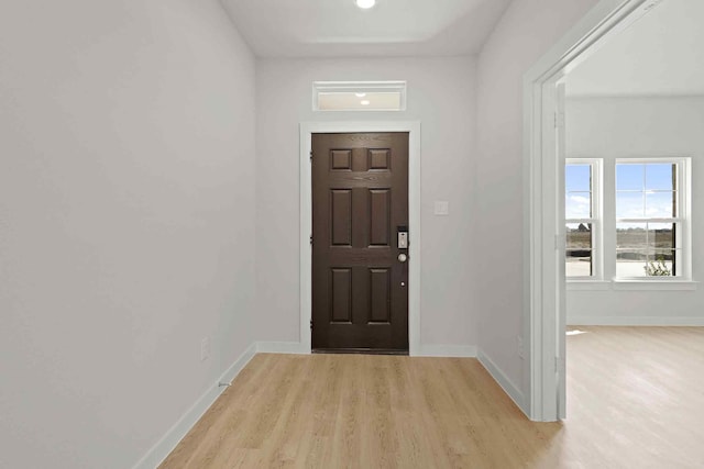 foyer entrance with light hardwood / wood-style flooring