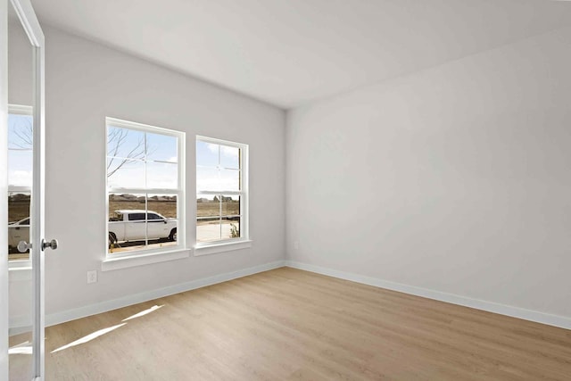 unfurnished room with light wood-type flooring