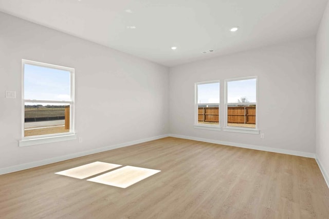 spare room featuring light hardwood / wood-style flooring