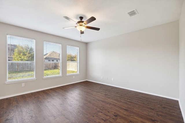 unfurnished room with ceiling fan and dark hardwood / wood-style flooring