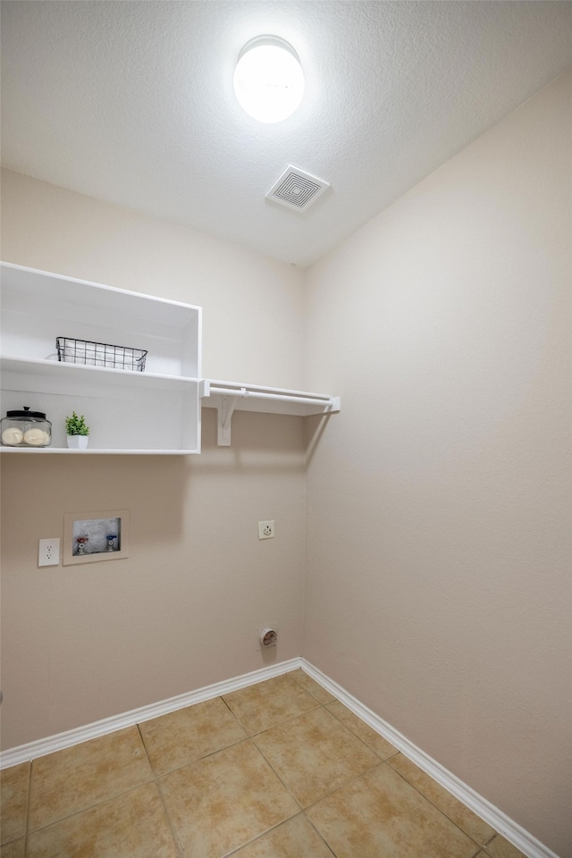 laundry room featuring tile patterned floors, hookup for an electric dryer, a textured ceiling, and hookup for a washing machine