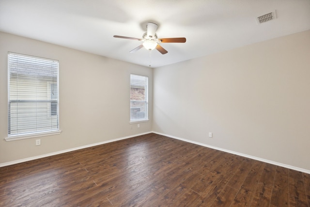 unfurnished room with ceiling fan and dark hardwood / wood-style flooring