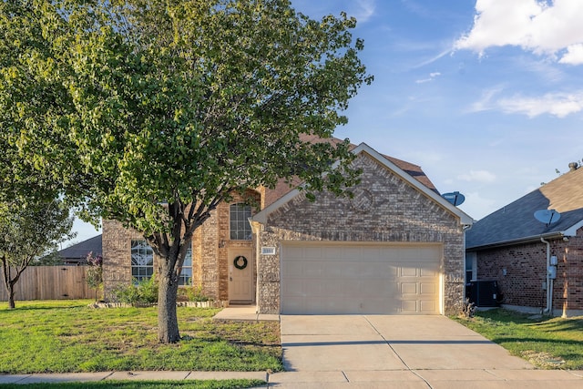 view of front property with a garage, a front yard, and central AC