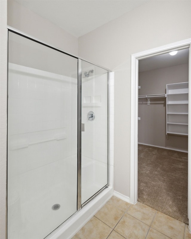 bathroom with tile patterned floors and walk in shower