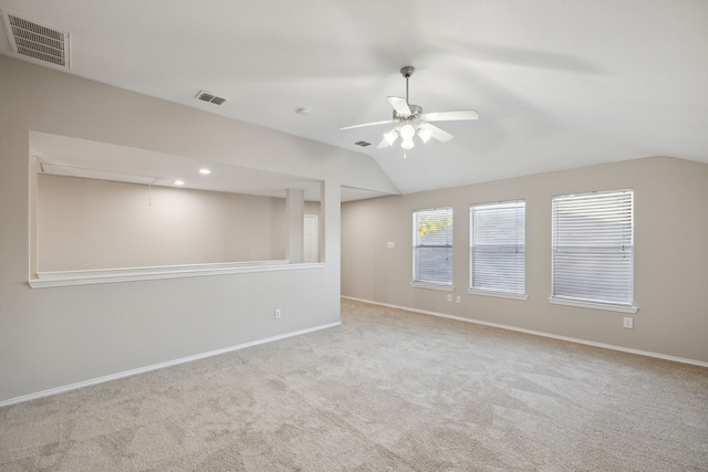 empty room featuring light carpet, ceiling fan, and lofted ceiling