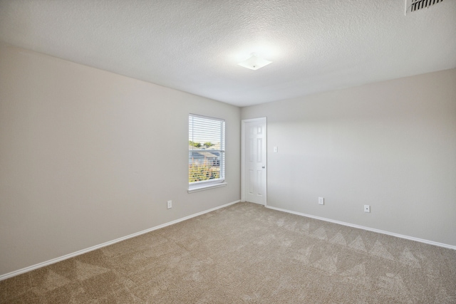 unfurnished room with a textured ceiling and carpet floors