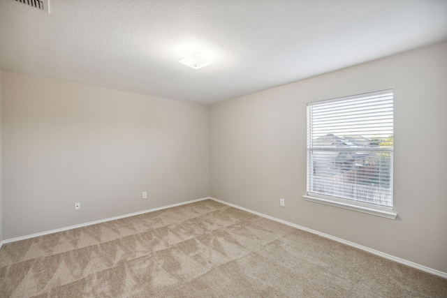 empty room with light colored carpet