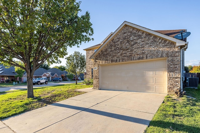 exterior space featuring a garage and cooling unit