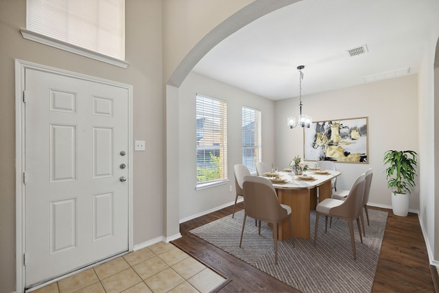 dining area with an inviting chandelier and light wood-type flooring