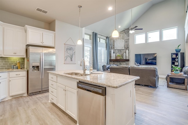 kitchen with appliances with stainless steel finishes, ceiling fan, and white cabinets