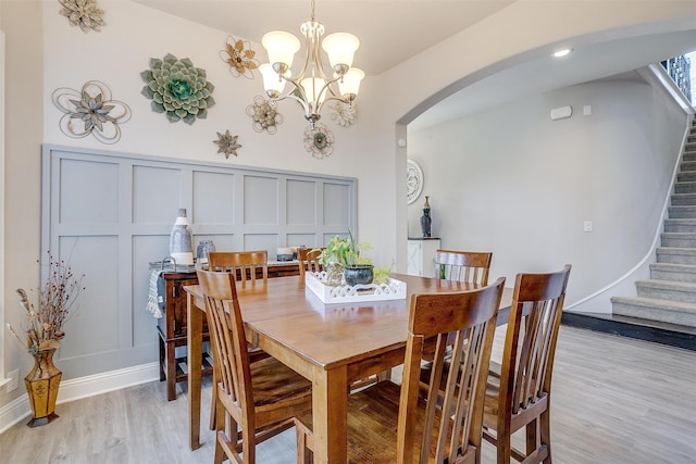 dining room with an inviting chandelier and light hardwood / wood-style floors