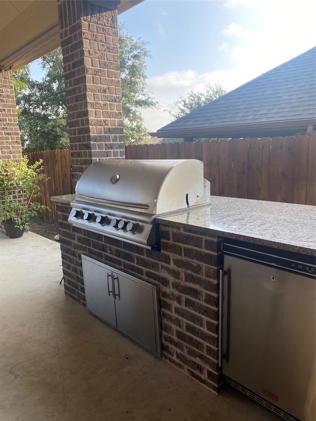 view of patio / terrace featuring exterior kitchen and grilling area