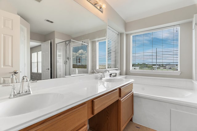 bathroom featuring plus walk in shower and vanity