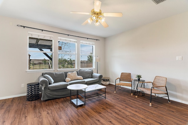 living room with a brick fireplace, dark hardwood / wood-style floors, crown molding, and ceiling fan