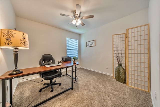 carpeted home office featuring ceiling fan