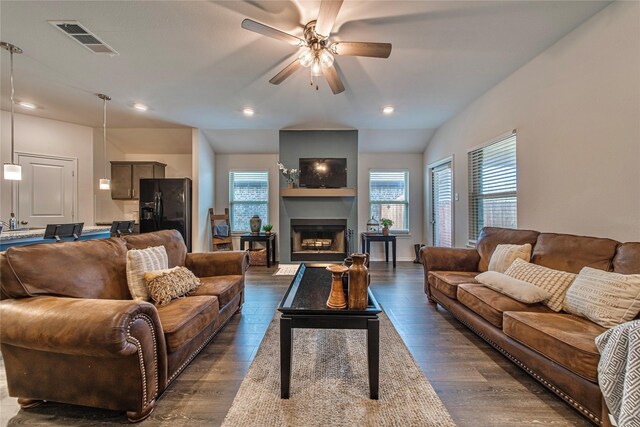 living room featuring vaulted ceiling, dark hardwood / wood-style flooring, and ceiling fan