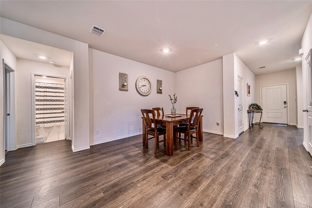 dining area with dark hardwood / wood-style floors