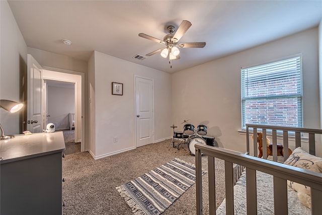 bedroom featuring carpet, ceiling fan, and a nursery area