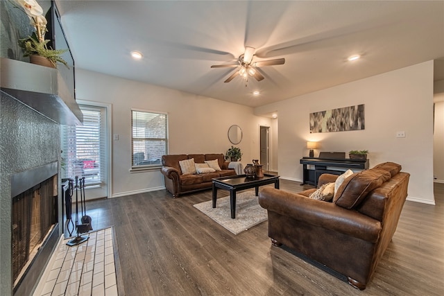 living room featuring ceiling fan and dark hardwood / wood-style flooring