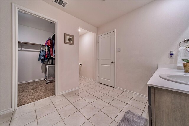 bathroom with tile patterned floors and vanity