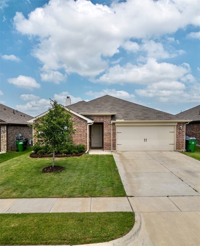 view of front of house featuring a front yard and a garage