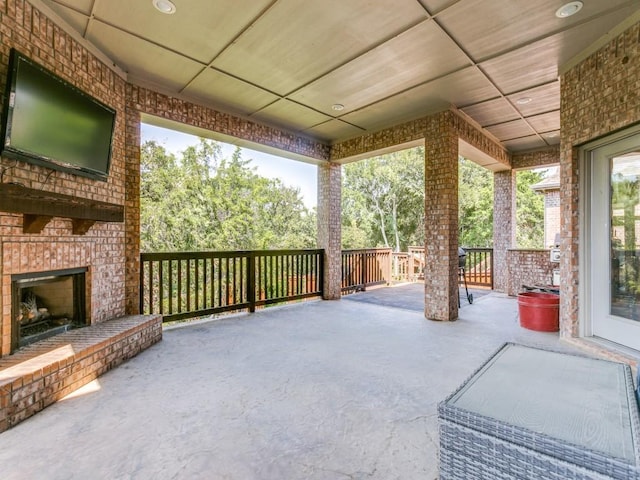 view of patio / terrace featuring an outdoor brick fireplace