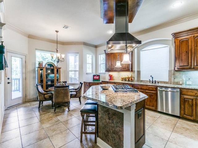 kitchen featuring island range hood, decorative light fixtures, appliances with stainless steel finishes, a notable chandelier, and a kitchen island