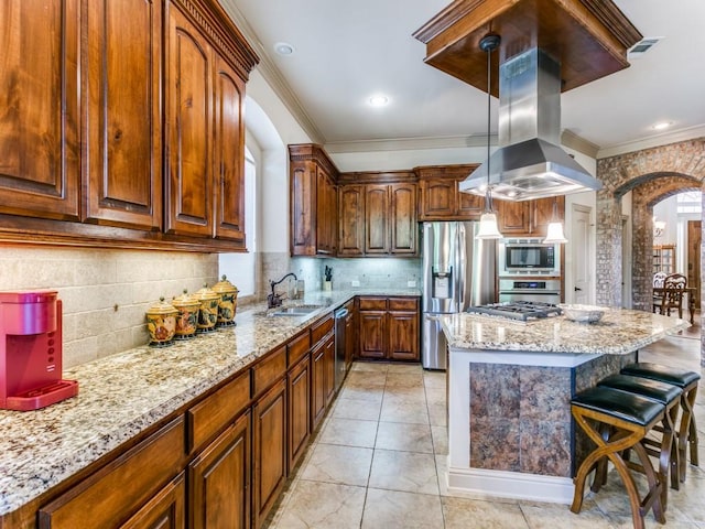 kitchen with crown molding, decorative backsplash, decorative light fixtures, island exhaust hood, and stainless steel appliances