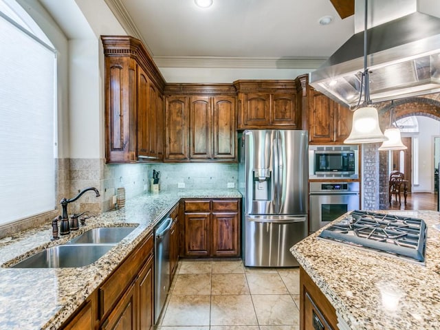 kitchen featuring appliances with stainless steel finishes, island range hood, crown molding, sink, and pendant lighting