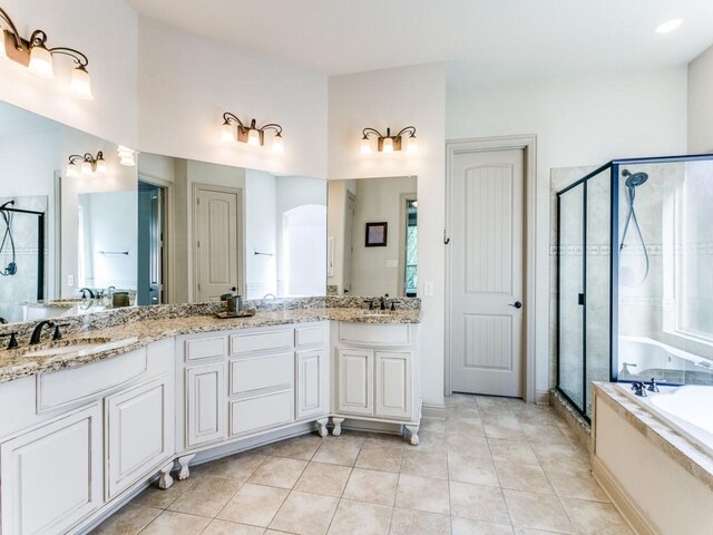 bathroom featuring tile patterned flooring, vanity, and separate shower and tub