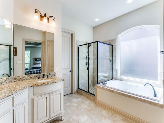 bathroom with tile patterned floors, vanity, and shower with separate bathtub