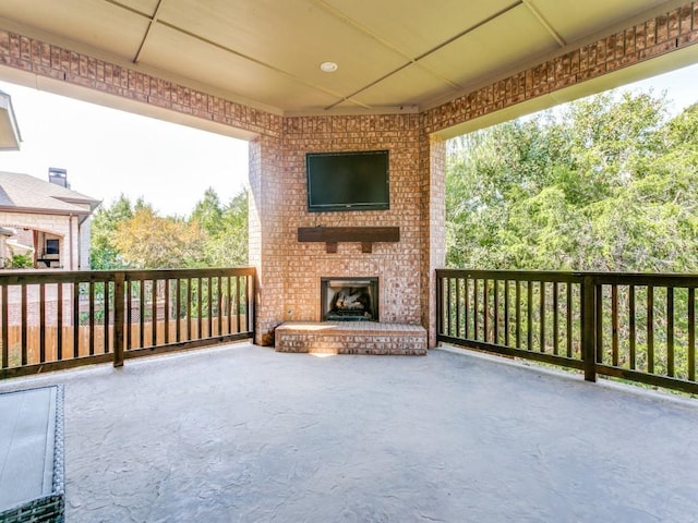 view of patio / terrace featuring an outdoor brick fireplace