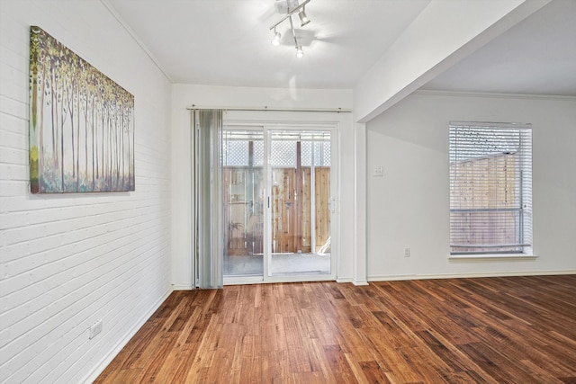 spare room featuring hardwood / wood-style floors and ornamental molding