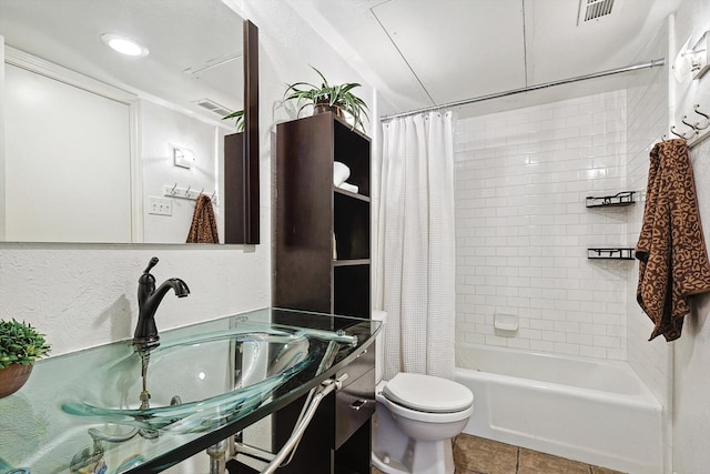 full bathroom with tile patterned flooring, shower / bath combo, toilet, and sink