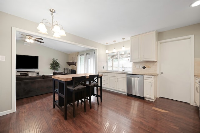 kitchen featuring dishwasher, dark hardwood / wood-style floors, ceiling fan with notable chandelier, white cabinets, and decorative light fixtures