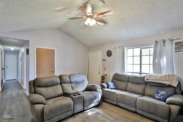 living room featuring light hardwood / wood-style floors, a textured ceiling, lofted ceiling, and ceiling fan