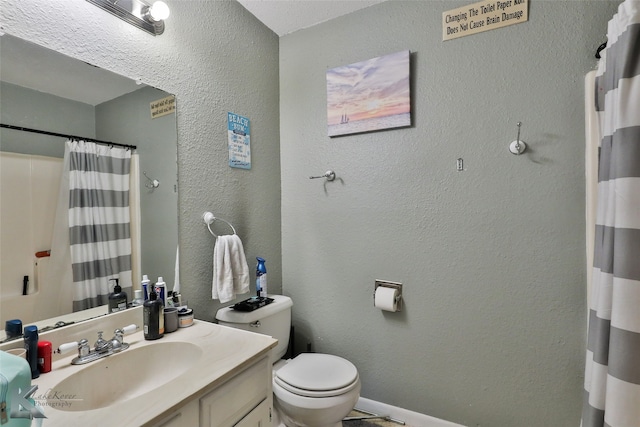 bathroom featuring curtained shower, vanity, and toilet