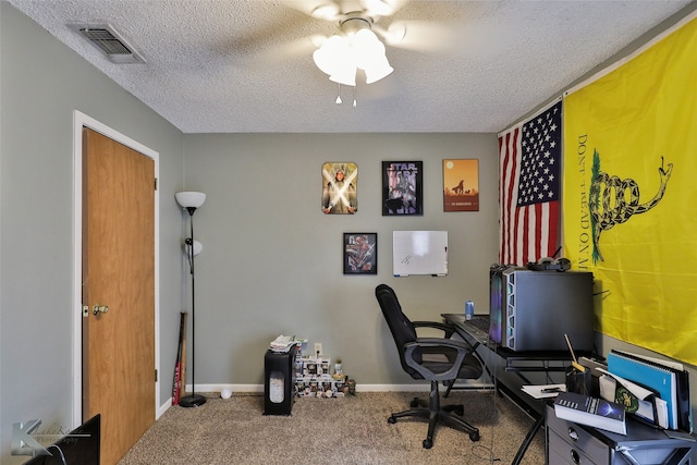 home office featuring carpet floors and a textured ceiling