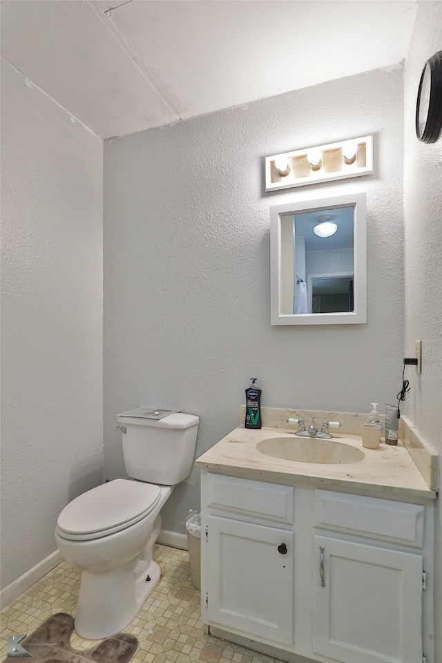 bathroom with tile patterned floors, vanity, and toilet