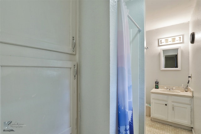 bathroom featuring vanity and curtained shower