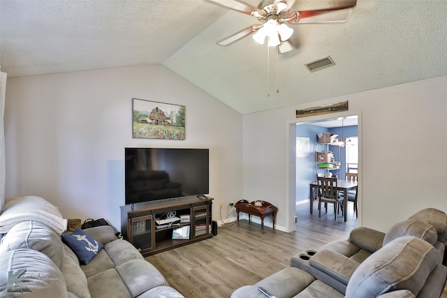 living room featuring light wood-type flooring, lofted ceiling, and ceiling fan