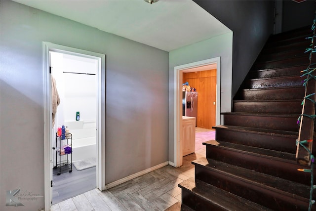 staircase with wood-type flooring