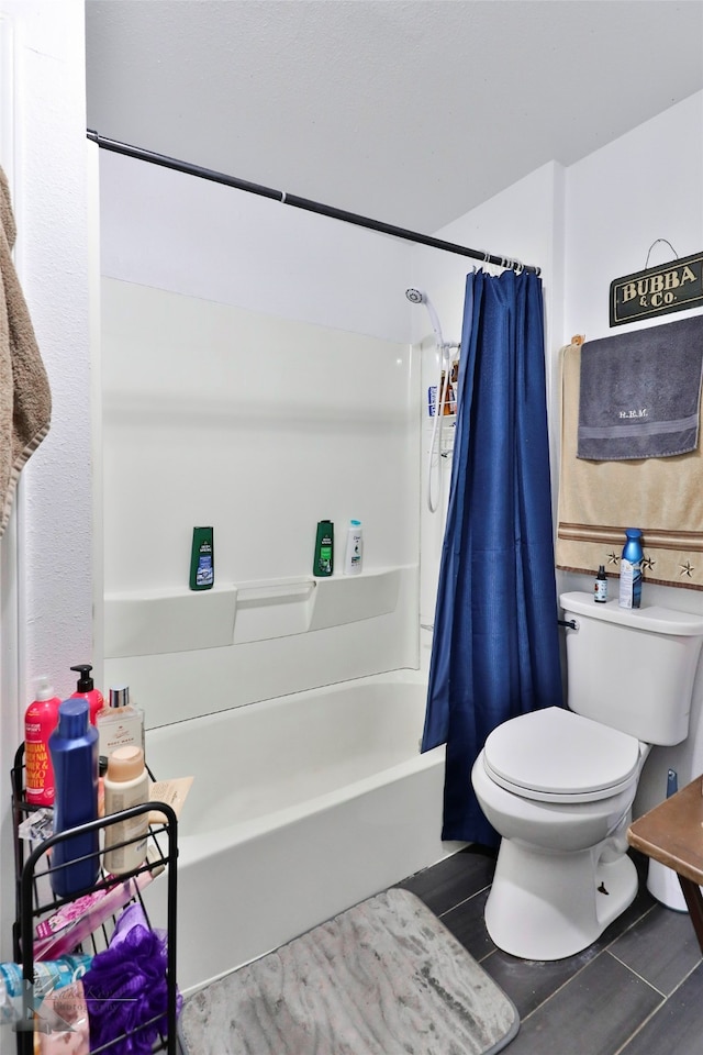 bathroom with toilet and shower / bath combo