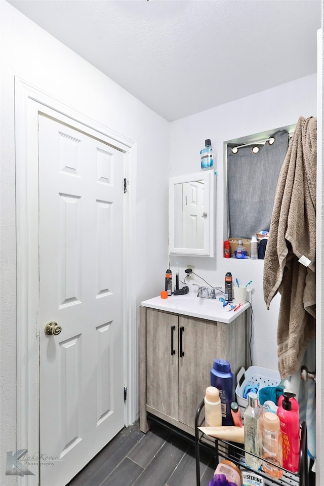 bathroom featuring wood-type flooring and vanity