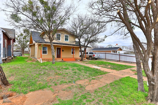 rear view of property with a lawn