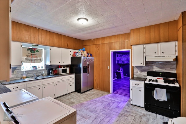 kitchen with light parquet floors, white appliances, white cabinetry, and sink