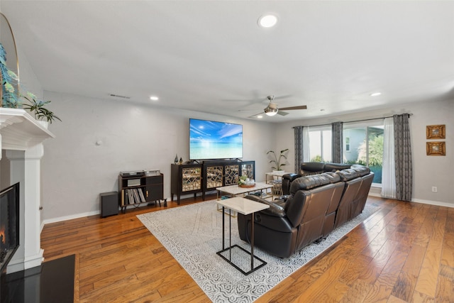 living room featuring hardwood / wood-style floors and ceiling fan