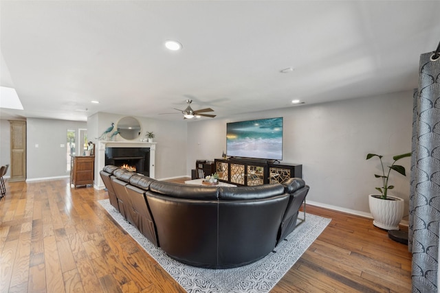 living room featuring hardwood / wood-style floors and ceiling fan